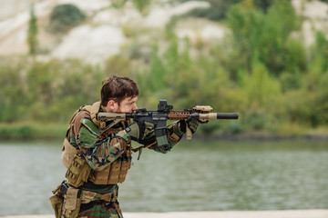Fototapeta premium rangers to aim and shoot at a target with automatic weapons