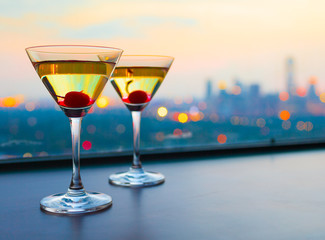 Cocktail glasses with city view.