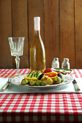 Roasted asparagus and tasty colorful pasta with vegetables on plate on wooden table background