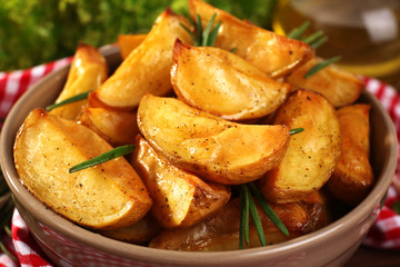 Baked potato wedges on table, closeup