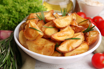 Baked potato wedges on table, closeup