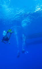 Silhouette of diver with sun disk behind