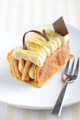 Napoleon cake on white plate with a fork