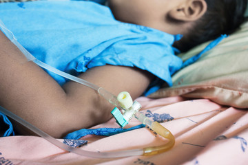 Sick little boy lying in a hospital IV.
