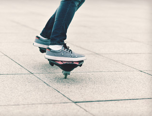 young woman legs riding on ripstick