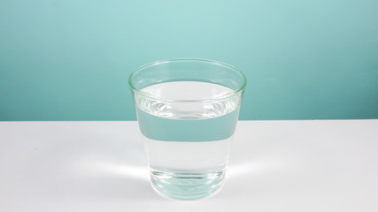 The glass of pure water on white table. (2)