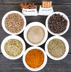 Spices and herbs in  bowls.