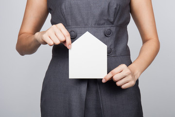 picture of woman holding paper house