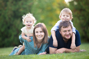 Fototapeta premium Couple with two kids in park