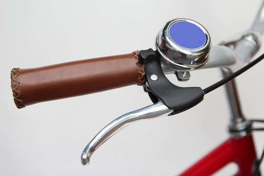 bicycle hand-grip with ancient ring bell isolated on white background. - Powered by Adobe