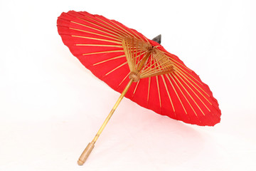 A handmade red, Asian parasol or umbrella isolated