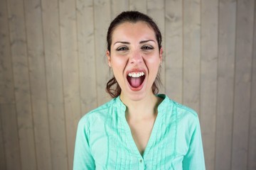 Portrait of screaming woman suffering from headache 