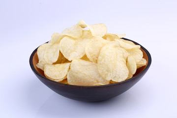 Crispy potato chips in wooden bowl isolated on white background