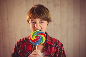 Pretty young woman eating lollipop 