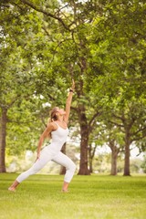 Obraz na płótnie Canvas Woman exercising with hand raised 