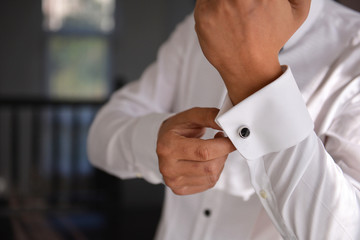 close up of a hand man how wears white shirt and cufflink