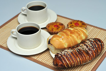 red bean bread and bread with berry on bamboo mat with hot coffee