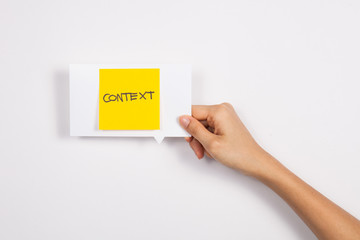 Context message concept. Hand holding post-it note