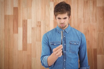 Concentrated hipster holding straight edge razor