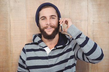 Hipster with hooded shirt using mobile phone