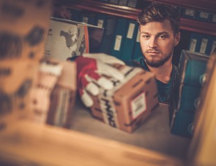 Worker on a automotive spare parts warehouse