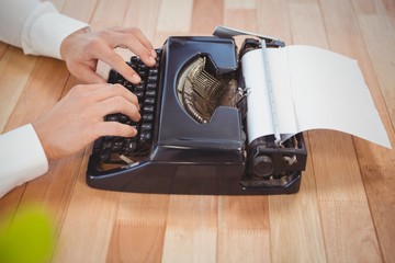 Businessman using typewriter at desk in office