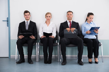 Businesspeople Sitting On Chair For Giving Interview