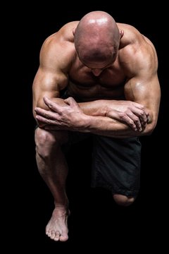 Bodybuilder Kneeling Down