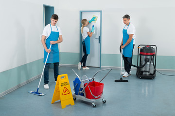 Janitors Cleaning Corridor