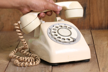 Retro rotary telephone on wood table