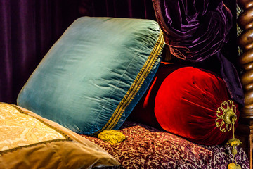 Closeup of velvet ,decorative pillows on bed.