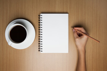 woman is drawing a something an empty paper