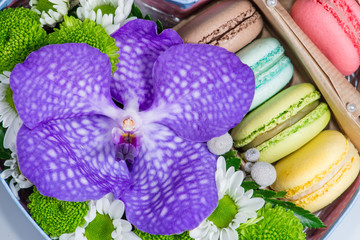 Closeup of  Flowers and macaroon. Shallow depth of field, focus