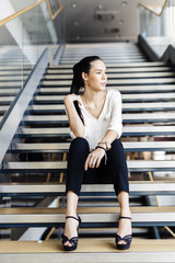 Businesswoman sitting on stairs