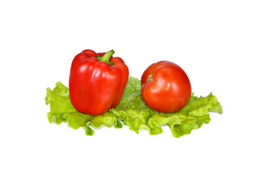 Beautiful red pepper and tomato on lettuce leaves.