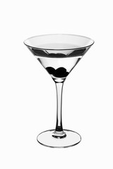 Wide glass on high legs with olives in a clear fluid.