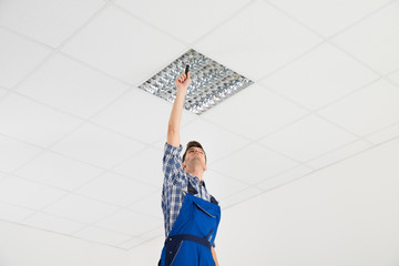 Electrician Installing Ceiling Light