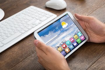 Businessperson Holding Mobile Phone With Apps