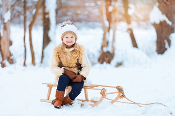 Little girl enjoying a day out playing in the winter forest