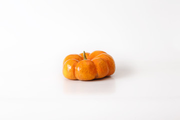 Orange halloween pumpkin gift on white background