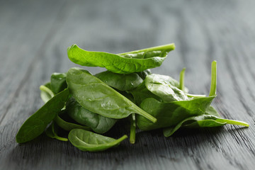 fresh spinach leaves on wooden table