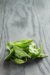 fresh spinach leaves on wooden table