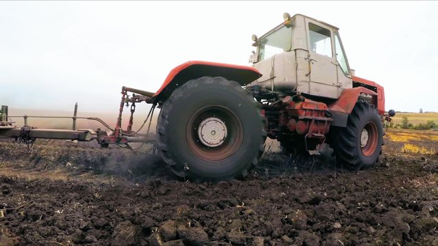 Rural Tractor Cultivating Land At Field