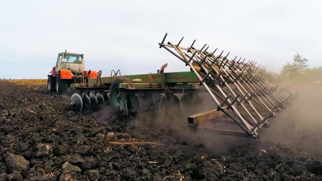Rural Tractor Trailer Cultivating Soil Of Agricultural Field