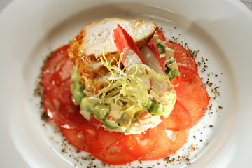 salad with crab sticks, fried chicken and tomatoes