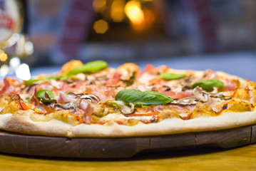 Pizza capricciosa with ham and mushrooms