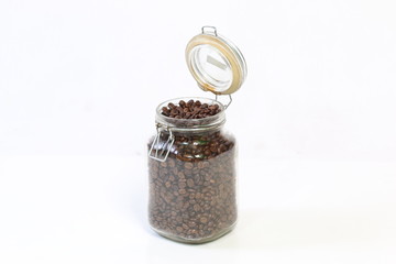 jar glass with coffee beans inside on white background