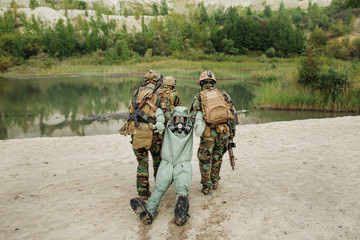 Army rangers captured a scientist with protective mask and prote