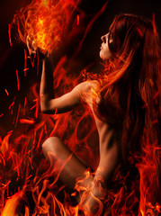 Red hair naked girl and fire - obrazy, fototapety, plakaty