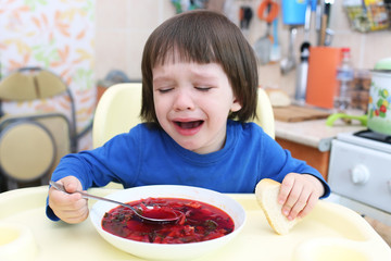 Crying child dont want to eat red soup